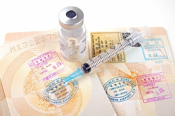 stamped passport pages with medical vaccination equipment on a white background