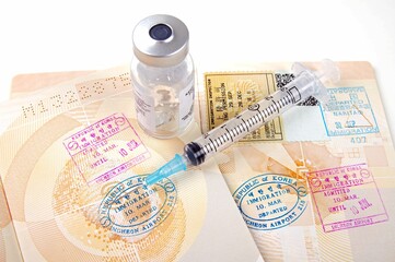 stamped passport pages with medical vaccination equipment  on a white background 