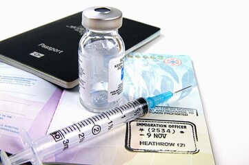 medical vaccination equipment and australian passports  with immigration stamp on a white...