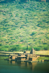 holly religious lake with ancient temple and mountain background at morning image is showing the beauty of Bhutanatha Temple on the shores of Agastya Tirtha at Badami karnataka india.