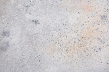 Light background of decorative plaster with abstract spots. Unusual texture of white or gray wall with beautiful patterns, creative surface background. Finishing coating for building cladding.