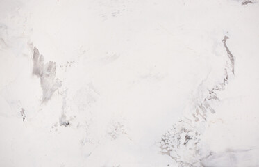 Light background of decorative plaster with abstract spots. Unusual texture of white or gray wall with beautiful patterns, creative surface background. Finishing coating for building cladding.