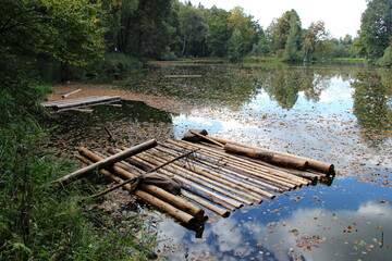 Raft on the pond, covered with autumn leaves