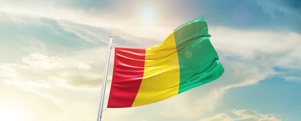 Guinea national flag cloth fabric waving on the sky - Image