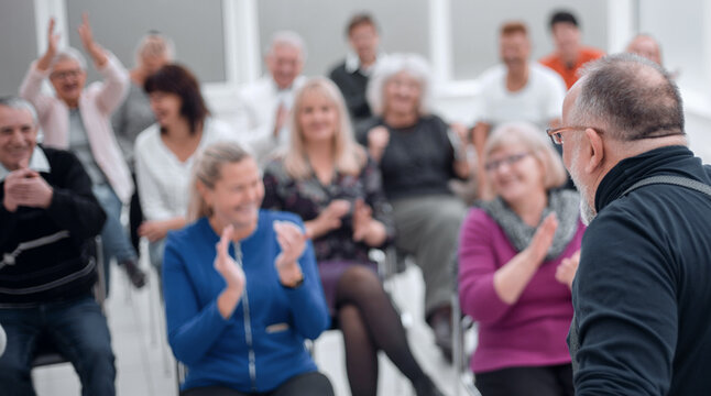 Mature caucasian man gives a speech in meeting in modern open office - Powered by Adobe