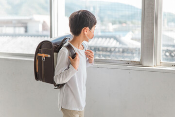 学校でマスクをつけている小学生の男の子（顔なし）

