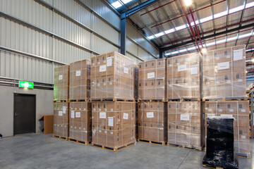 Stack of cardboard box cartons or parcels in logistics warehouse.