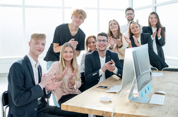 group of happy employees applauds their overall success