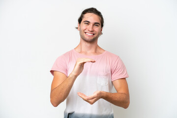 Caucasian handsome man isolated on white background holding copyspace imaginary on the palm to...