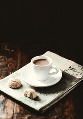 Cup of coffee on dark wooden background. Soft focus. Copy space.