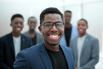 young businessman pointing to his business team