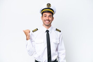 Airplane pilot over isolated white background pointing to the side to present a product