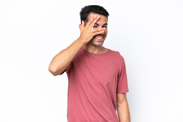 Young handsome man over isolated white background covering eyes by hands and smiling