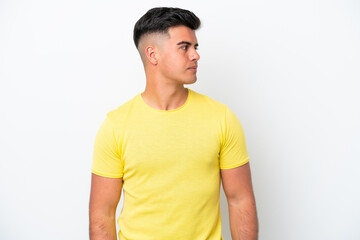 Young caucasian handsome man isolated on white background looking to the side