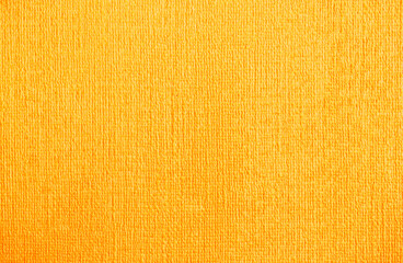 Golden wall with abstract spots as a background. Beautiful golden texture with patterns, decorative plaster. Modern bright wall painting in trendy shades, unusual spotted yellow and gold surface.