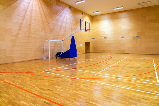 Photo of empty basketball gym with movable basket