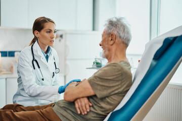 Obraz premium Female doctor talks to senior patient during medical exam at clinic.