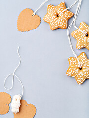 Christmas background with homemade gingerbread cookies as a decoration and matching gift tags. Festive food, New Year celebration, traditions, winter holiday and culinary concept. Copy space.