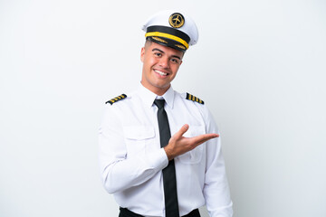 Airplane pilot caucasian man isolated on white background presenting an idea while looking smiling towards