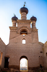 Old ruined church. Bent crosses and broken walls of the temple, ancient forged frames on the windows. Christian monastery.