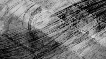 Zelfklevend Fotobehang Aerial top view texture car skid tire marks on race track, Black tire mark tread marks on race track texture and background. © Darunrat
