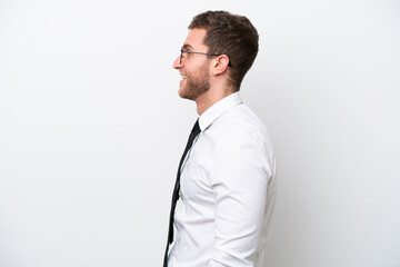 Fototapeta premium Young business caucasian man isolated on white background laughing in lateral position