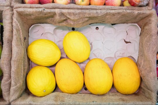 Yellow melon in crate at supermarket
