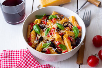 Pasta alla Norma with eggplant, tomatoes, cheese and basil. Italian food. Vegetarian food.