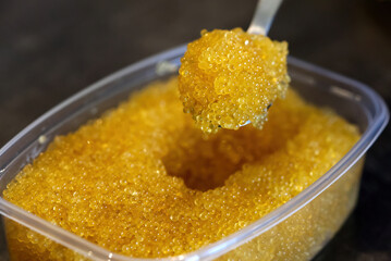 Pike caviar or roe in spoon above the bowl. close up