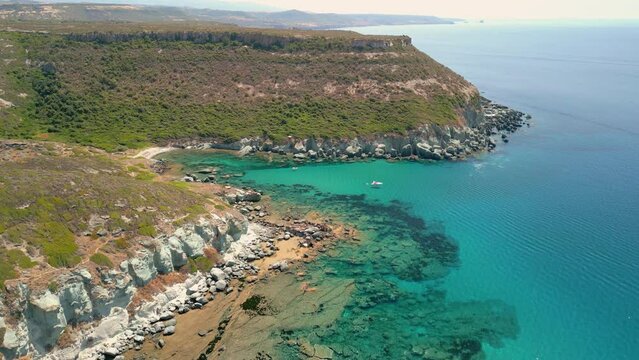 Aerial view of cliffs in Sardinia over the turquoise blue transparent sea
