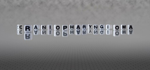 craniopharyngioma word or concept represented by black and white letter cubes on a grey horizon background stretching to infinity