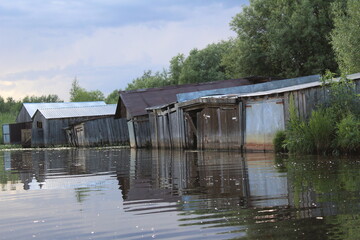 wooden garages for storing fishing boats on the river in the village 