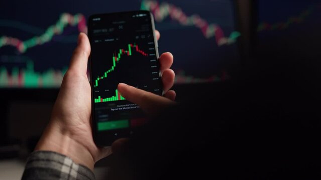 Business woman businessman manages business selling buying currency on stock exchanges currency trading online, graph charts dynamics on smartphone screen. Hands moving bright graph

