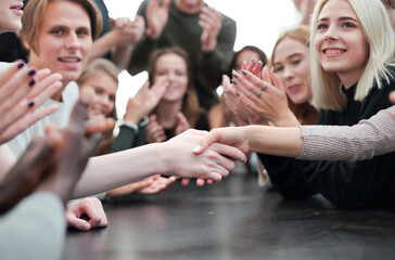 group of young people applauding the participants of the meeting