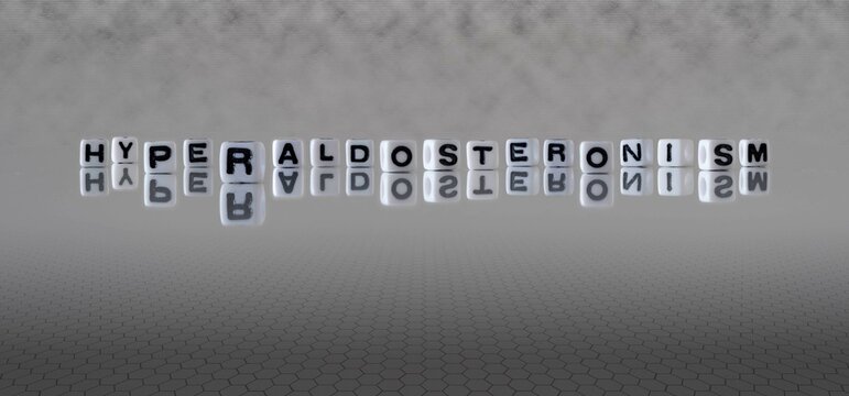hyperaldosteronism word or concept represented by black and white letter cubes on a grey horizon background stretching to infinity