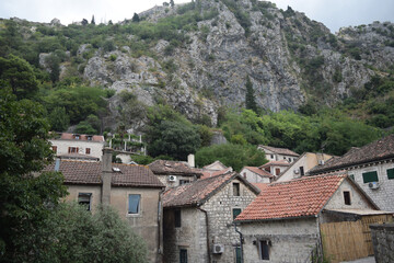 roofs of houses and high mountains in Kotor, Montenegro