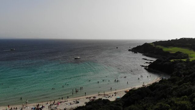 Drone flies over Grande sperone beach in Corsica island starting from the Coast to the foreshore