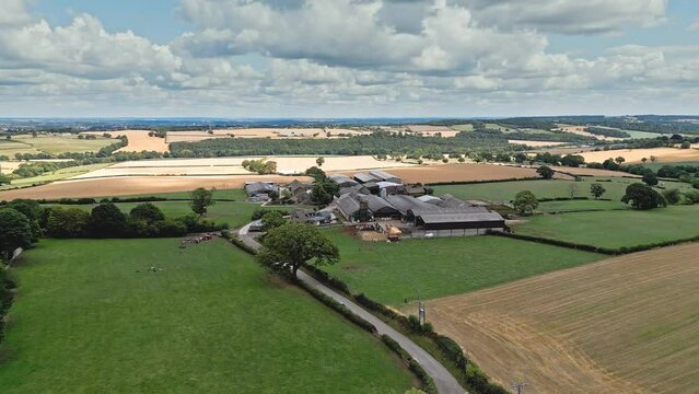 Aerial footage of a modern day farm and out buildings in a rural Yorkshire landscape, shot in Emley Village West Yorkshire. England