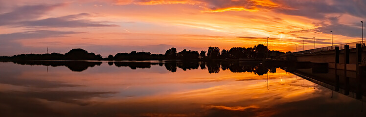 Fototapeta premium Beautiful sunset view with reflections near Plattling, Isar, Bavaria, Germany
