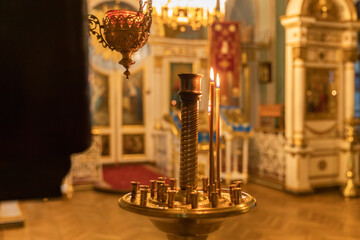 Orthodox Church. Christianity. Festive interior decoration with burning candles and icon in...