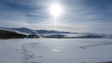 a frozen snowy lake