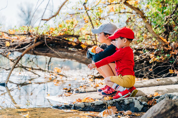 little child playing in autumn park
