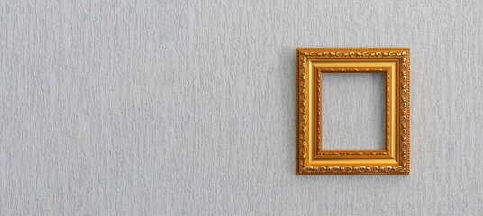Baguette frame for picture or photograph of gold color hangs on  light wall.