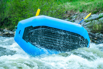 Flipping raft during whitewater adventure