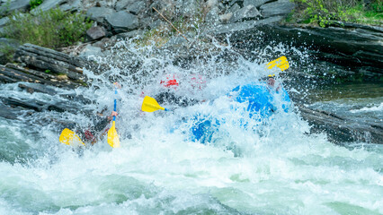 Big splash in the rapids during whitewater rafting trip