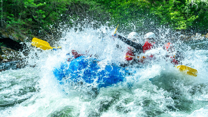 Big splash in the rapids during whitewater rafting trip