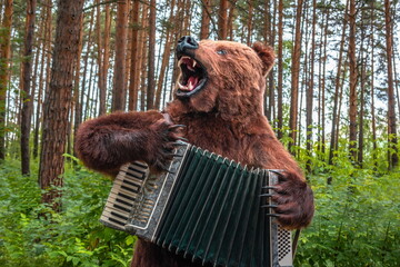 brown bear in the forest plays the accordion	
