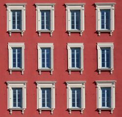 Typical facade in the south of France, on the French Riviera, windows with colored shutters