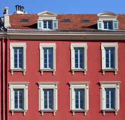 Typical facade in the south of France, on the French Riviera, windows with colored shutters