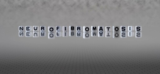 neurofibromatosis word or concept represented by black and white letter cubes on a grey horizon...